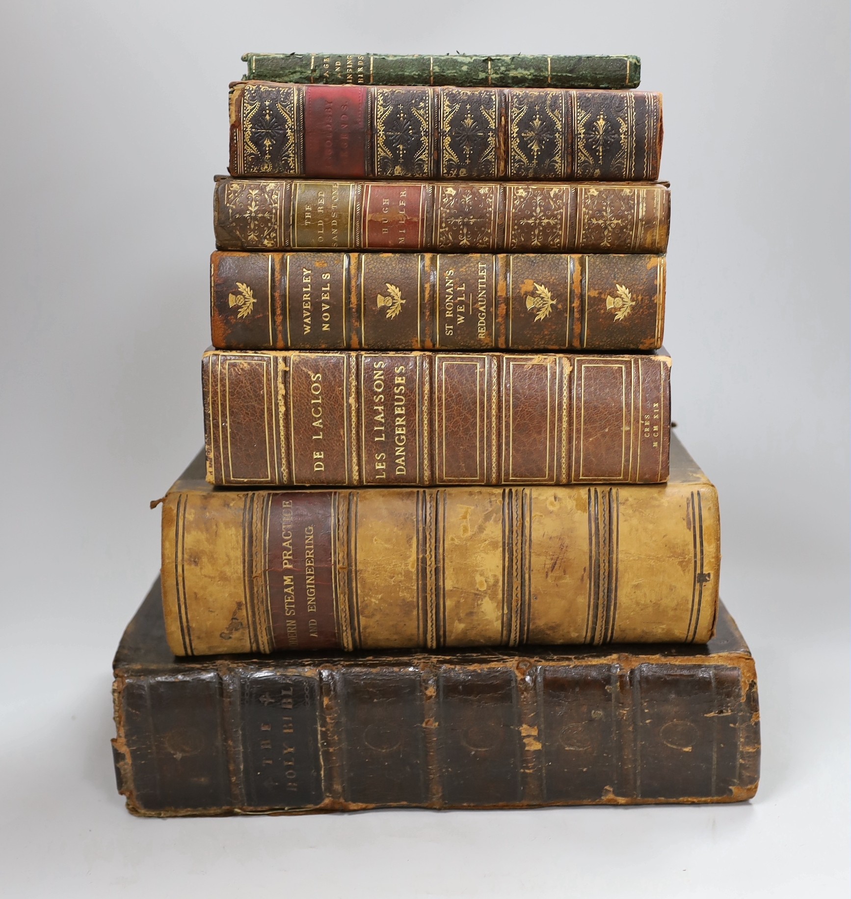 A brown leather bound Bible dated 1814, a volume of Modern Steam Practice and Engineering and five other leather bound books